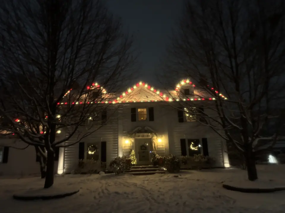 Colonial home with red and white Christmas lights