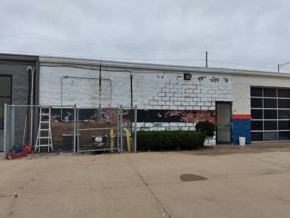 Rear wall of a commercial building with failing paint