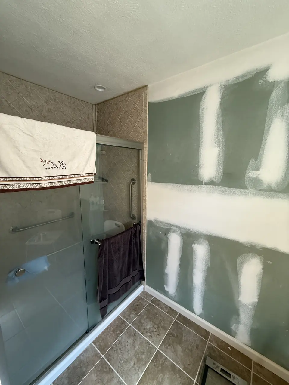 Bathroom walls covered in drywall patches