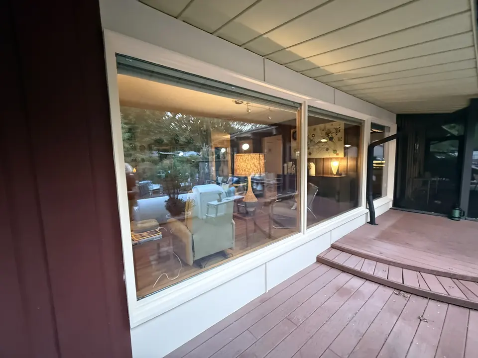 Large patio windows with freshly painted trim and panels
