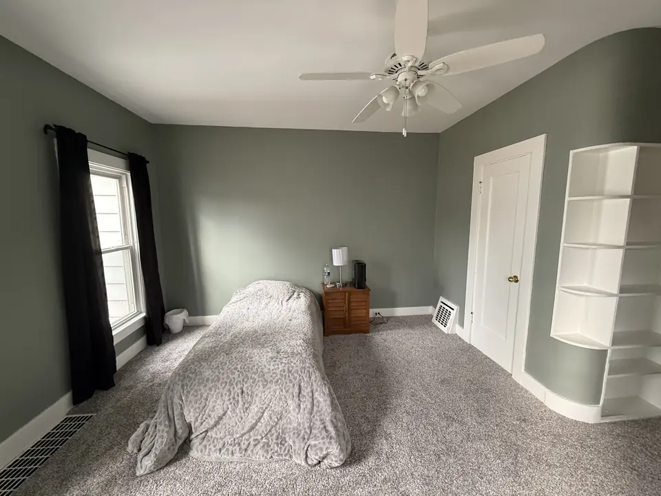 Freshly painted bedroom with new carpet in a renovated rental