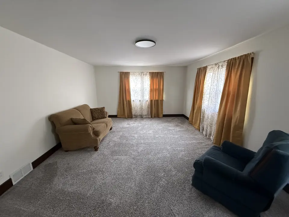 Renovated living room with fresh paint and new carpet