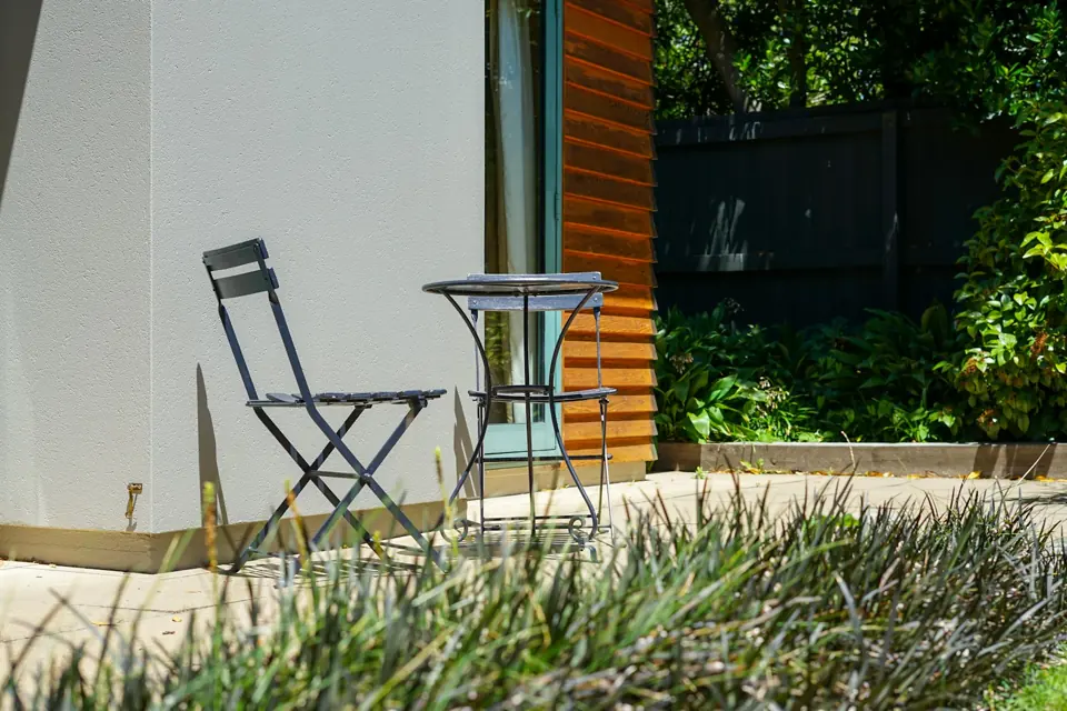 Clean, smooth concrete patio with bistro chairs